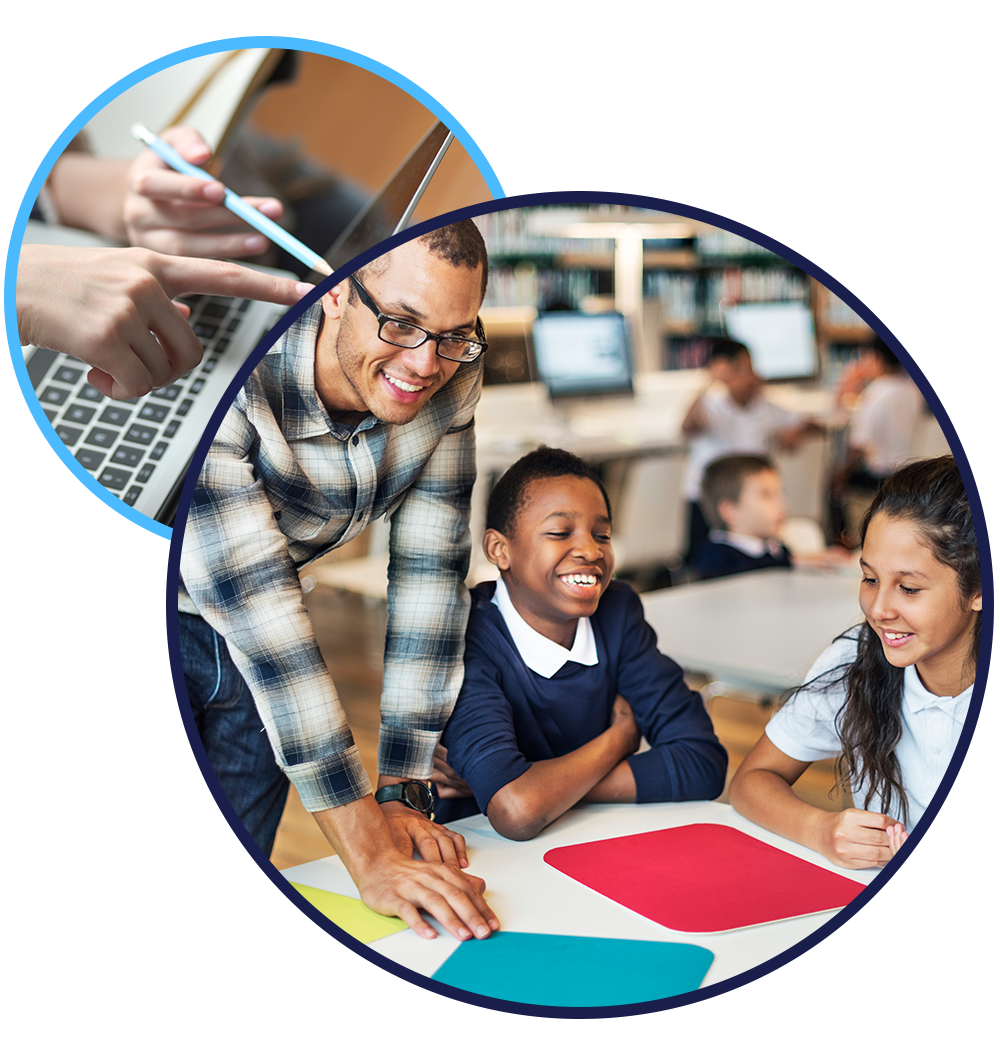 Teacher leaning over table with two pupils.